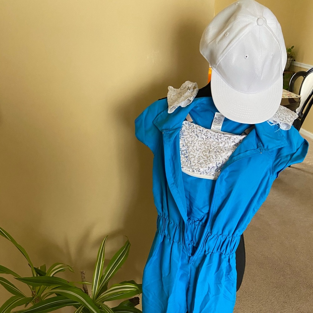 Blue jumpsuit paired with white sequined bra